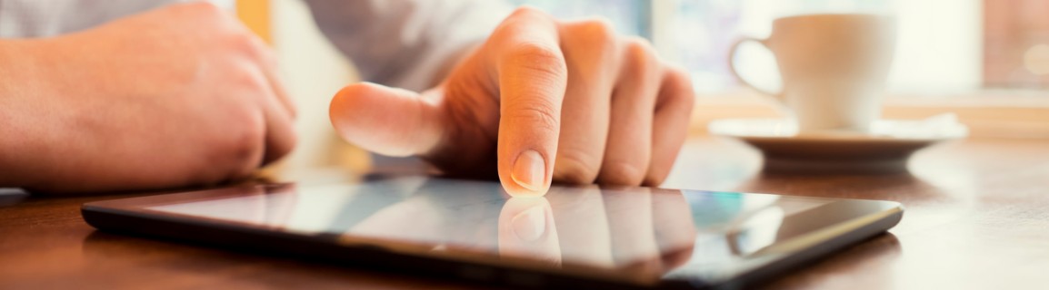 Reading security product manuals on a tablet.